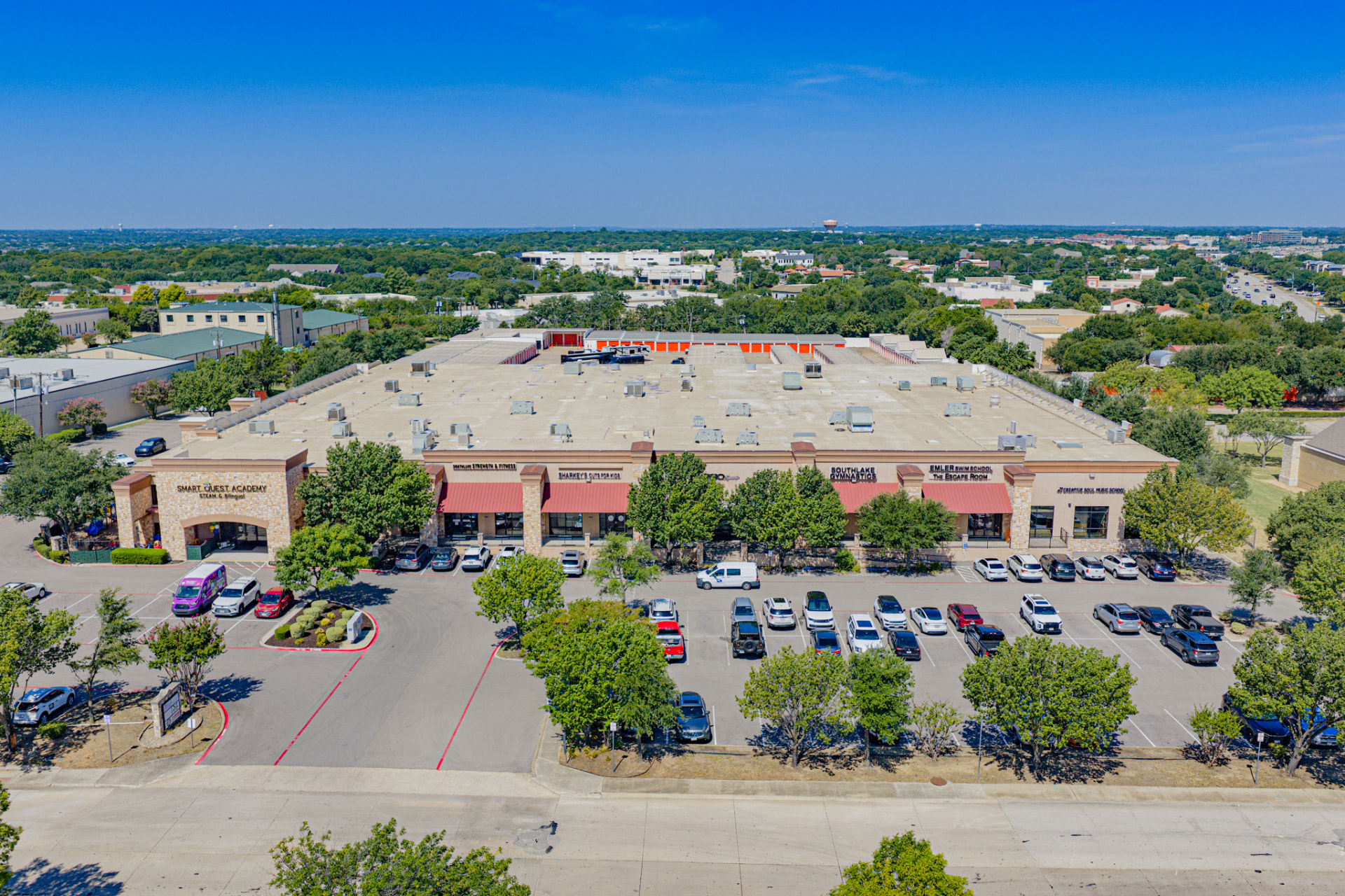 Aerial perspective of Southlake Commons building facade and parking field